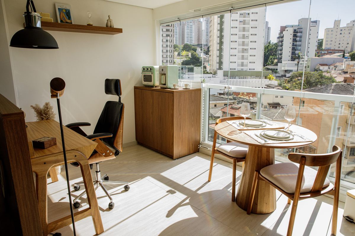 Varanda com mesa posta e vista da cidade — exemplo de ambiente preparado pela GuestNow